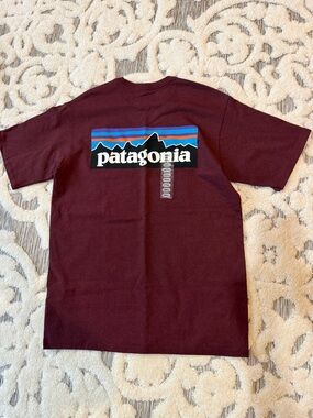 NWT size adult small Patagonia Short Sleeve Tee in Maroon with Multi-Color Logo